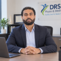 Haninder Dhillon, co‑owner and founder of DRS Physio & Wellness, sitting in the administrative office at the clinic.